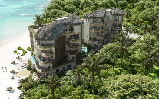 Aerial view of Naomi Beach Playa del Carmen — luxury beachfront residences on Xcalacoco Beach with oceanfront architecture surrounded by tropical jungle.