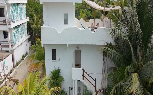 Casa Kuka Holbox investment property for sale – three-story building facade steps from Avenida Kuka and the beach