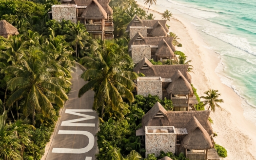 Invest in Tulum 2026: aerial view of the Tulum hotel zone road, Caribbean beach and Mayan pyramid, real estate analysis by Frank Ruiz Coldwell Banker Riviera Maya